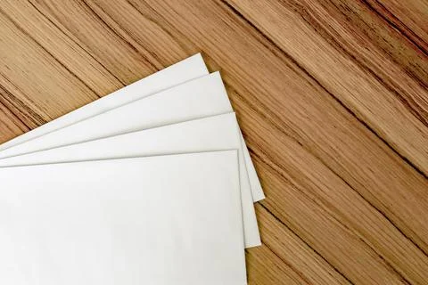 White envelope on board table Stock Photos