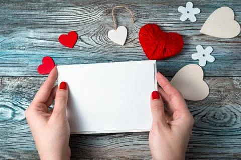 White envelope with an empty letter in the hands of a woman on a romantic Stock Photos