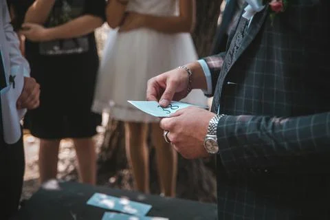 A white envelope in the hands of a man dressed in a suit Stock Photos