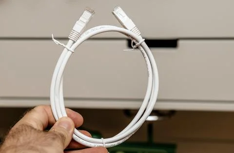 White Ethernet Cable Held in Hand Stock Photos