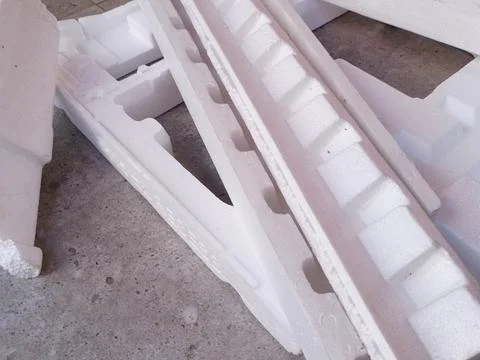 White Expanded Polystyrene Foam Packaging Fragments on Concrete Floor Stock Photos