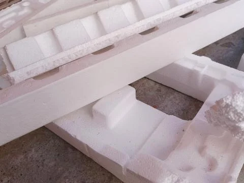 White Expanded Polystyrene Foam Packaging Fragments on Concrete Floor Stock Photos