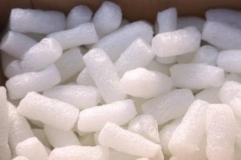 White expanded polystyrene foam pieces in cardboard box Stock Photos