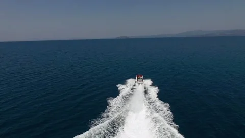 White expensive boat sailing at high speed through a clear blue sea, filmed w Stock Footage 134696502