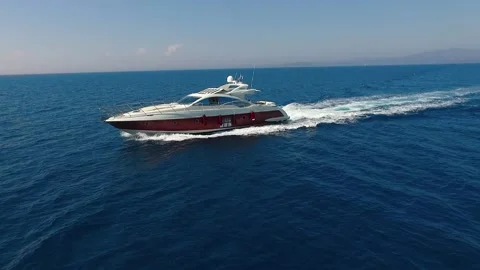 White expensive boat sailing through a clear blue sea, filmed with drone. Stock Footage 134693111