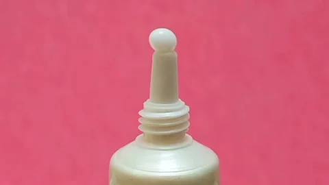 White Eye Cream Texture Squeezed from Tube on Pink Background, Skincare Closeup Stock Footage 325417831