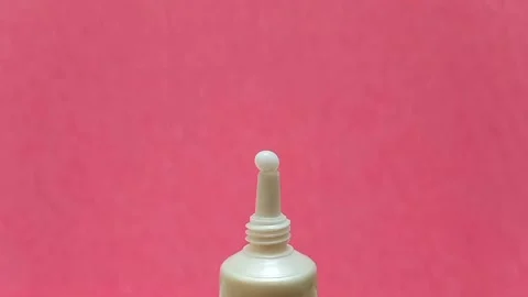 White Eye Cream Texture Squeezed from Tube on Pink Background, Skincare Closeup Stock Footage 325417833