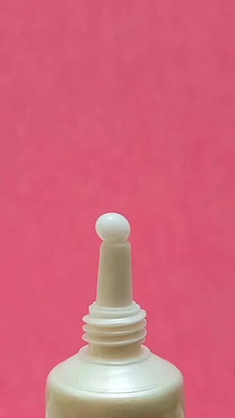 White Eye Cream Texture Squeezed from Tube on Pink Background, Skincare Closeup Stock Footage 325417838