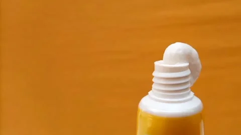 White Eye Cream Texture Squeezed from Tube on Yellow Background, Skincare Stock Footage 328291808