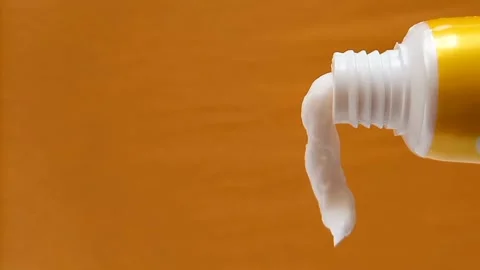 White Eye Cream Texture Squeezed from Tube on Yellow Background, Skincare Stock Footage 328291809