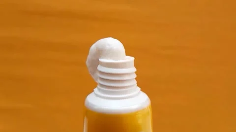 White Eye Cream Texture Squeezed from Tube on Yellow Background, Skincare Stock Footage 328291810