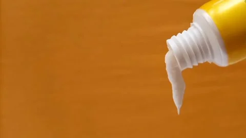 White Eye Cream Texture Squeezed from Tube on Yellow Background, Skincare Video stock 328291811