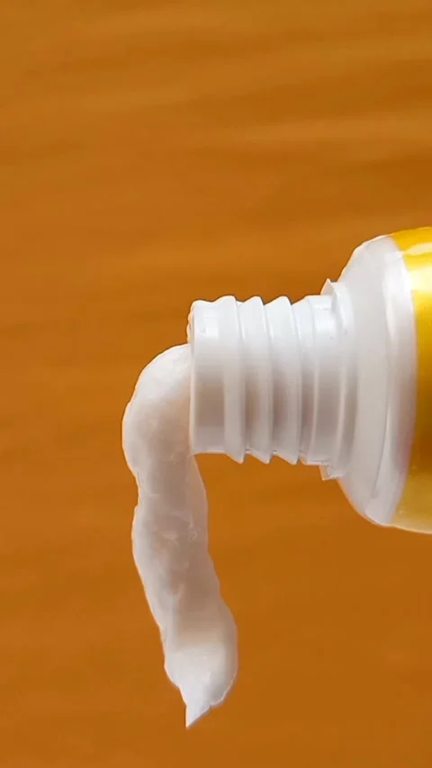 White Eye Cream Texture Squeezed from Tube on Yellow Background, Skincare Stock Footage 328291858