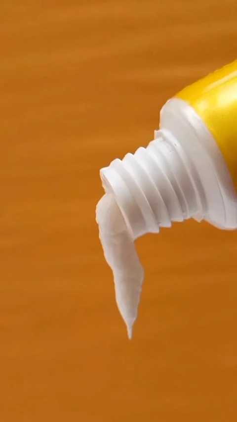 White Eye Cream Texture Squeezed from Tube on Yellow Background, Skincare Stock Footage 328291860