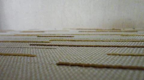 White fabric background with tiny brown lines. Close-up white cotton texture Stockfoto's