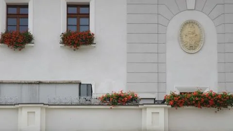 White facade with red geranium window boxes Stock Photos