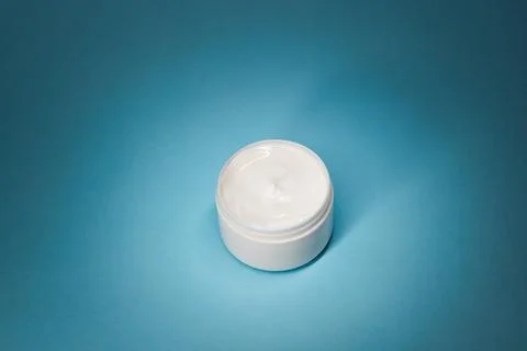 White Face Cream Container With Copy Space On Blue, Skincare Mockup 库存照片