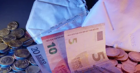 White Face Mask next to Euro Banknotes. Economy and healthcare in Europe Stock Footage