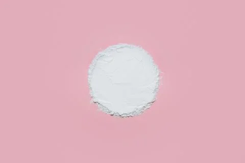 White face powder with empty circle inside on pink background Stock Photos