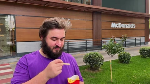 White fat man with beard eats French fries Stock Footage 340428031