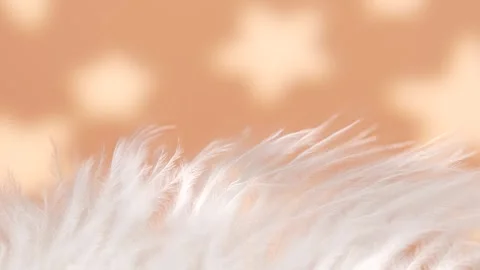 White Feather, macro. Slow motion. White fluff on beige background Stock Footage 299364213