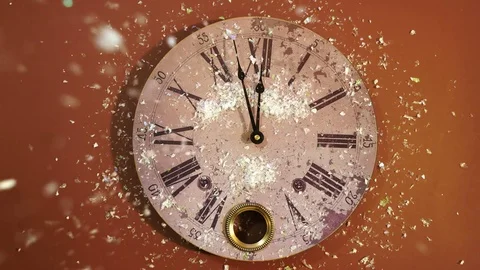 White feathers fall on a New Year clock on a brown background Stock Footage 82954137