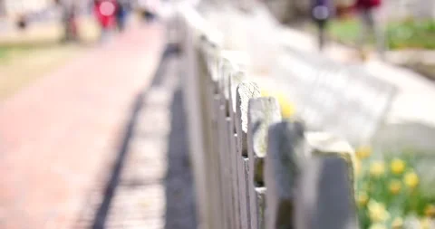 White fence during the spring day close up on post shallowed up the field Stock Footage 234589554