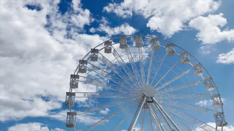 White Ferris Wheel with Fluffy Clouds Stock Footage 245814978