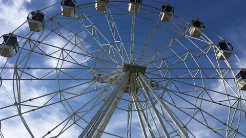 A white Ferris wheel is spinning Stock Footage 77569094