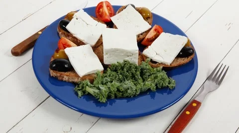 White feta greek cheese sandwich on blue plate Stock Footage