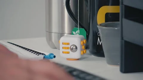 White Fidget Cube Stress Toy on Office Desk Stock Footage 328617741