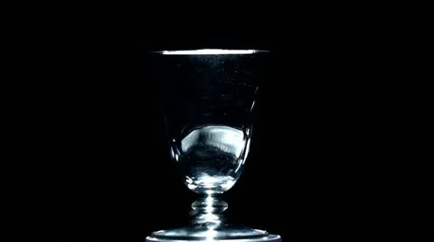 White figured glass rotates on a black background Stock Footage