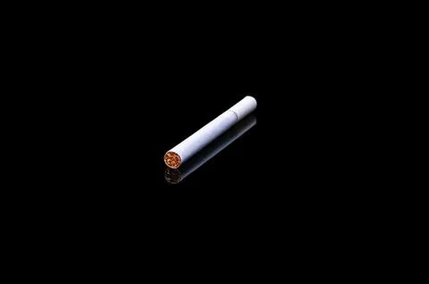 White filter cigarette on isolated black background with reflection Stock Photos