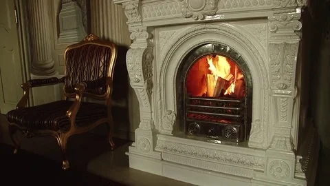 White fireplace in which the fire burns Stock Footage 69143749
