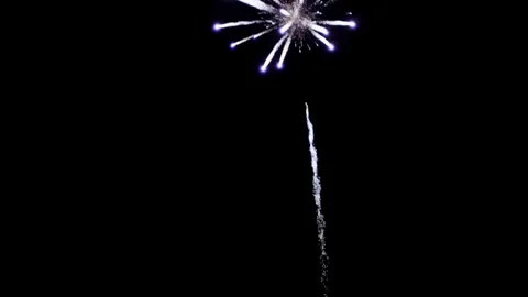 White firework trail explodes into purple and blue sparks Stock Footage 329675761