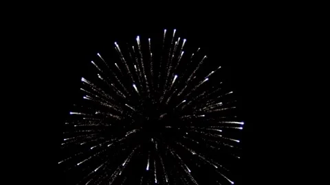 White fireworks explode brightly in the dark night sky Stock Footage 329676097