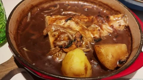White fish cooked in the oven with potatoes in onion sauce. Stock-Footage 313234798