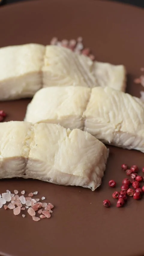 White fish fillets, seafood cooked with salt and spices. Fish fillets Stock Footage 311887351