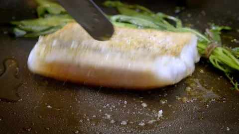 White fish pike-perch, zander together with herbs are fried in a hot pan. Stock Footage 302646078