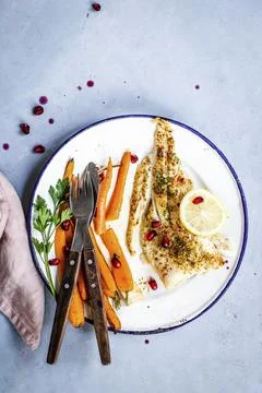 White fish with roasted vegetables and pomegranate food photography recipe id Stock Photos