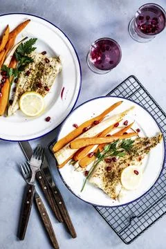 White fish with roasted vegetables and pomegranate food photography recipe id Stock Photos