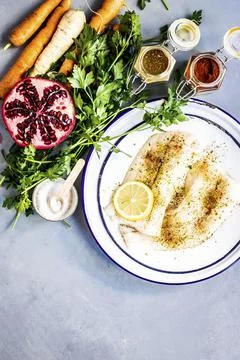 White fish with roasted vegetables and pomegranate food photography recipe id Stock Photos