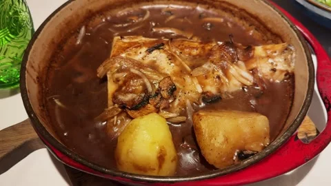 White fish stewed with potatoes in onion sauce. Stock Footage 309550876