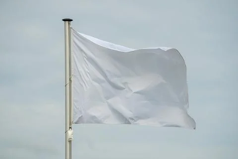A white flag is blowing in the wind Stock Photos