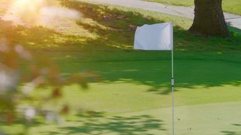 White Flag Blowing in Wind, Spring Green Lawn Golf Course Beautiful Background Stock Footage 109574661