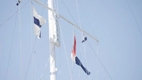 A white flag with a blue cross on it is hanging from a mast Stock Footage 302467239