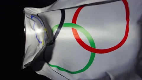 White flag with five Olympic rings flapping in the wind on black studio Stock Footage 154452891