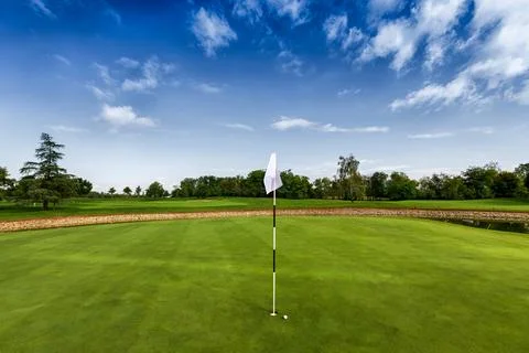 White flag of hole on golf course Stock Photos