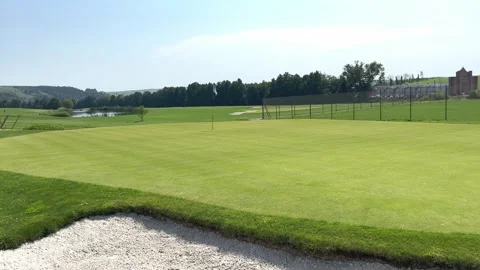A white flag is placed in the hole on the golf course Stock Footage 247760072