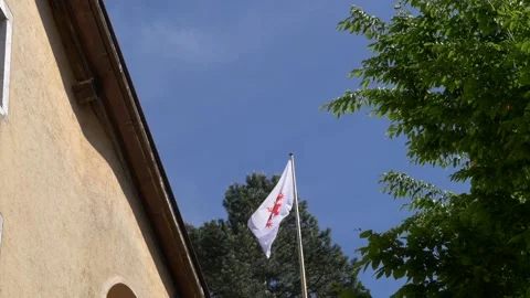 White flag with red ornament slightly waving in breeze Stock Footage 157007708